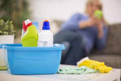 Office cleaners sanitising shared workspace surfaces in W1