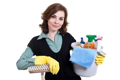 Professional cleaner vacuuming a W1 office floor