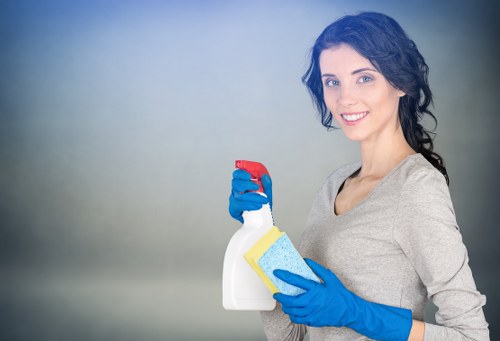 Technician removing stains with a carpet cleaner in W1