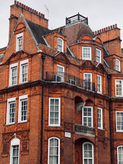 Photograph of a historic residential building on Gloucester Place in W1, featuring a cream-colored façade with classical architectural details, multiple windows with decorative trim, and a traditiona
